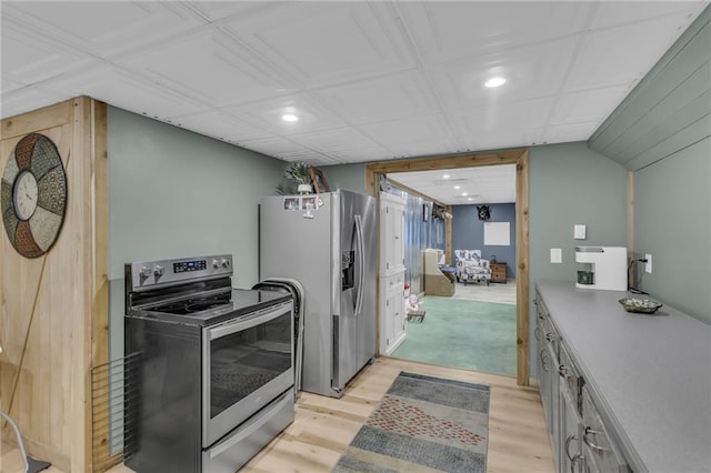 kitchen with gray cabinets, light wood-type flooring, and stainless steel appliances