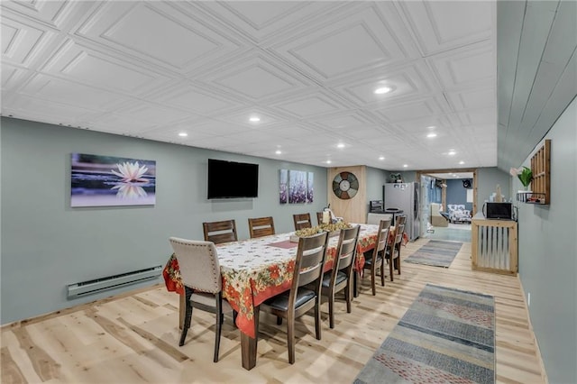 dining room featuring baseboard heating and light wood-type flooring