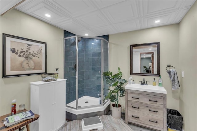 bathroom featuring vanity, an enclosed shower, and hardwood / wood-style flooring