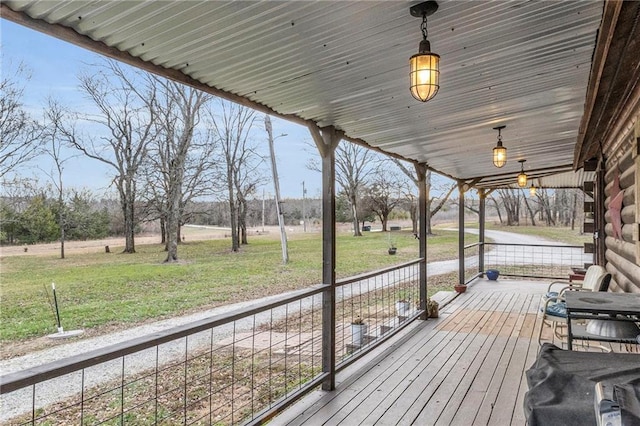 wooden terrace featuring a yard and a porch