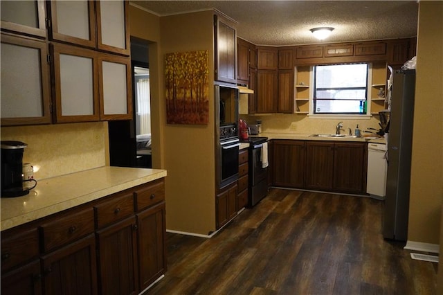 kitchen with sink, dark wood-type flooring, a textured ceiling, stainless steel range with electric stovetop, and black oven