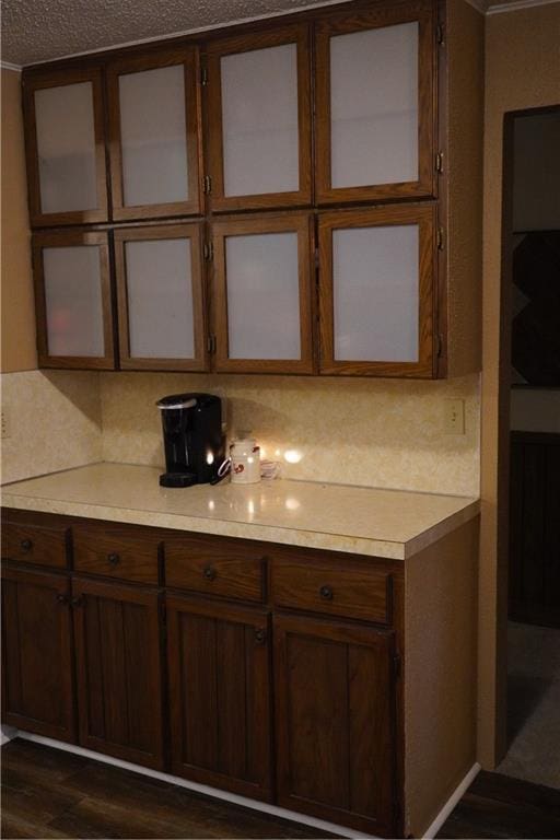 kitchen with decorative backsplash, dark hardwood / wood-style floors, and a textured ceiling