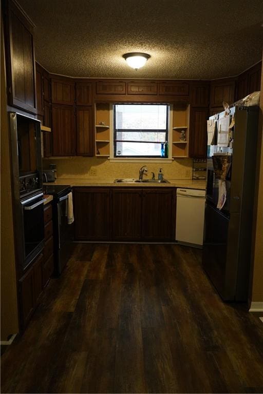 kitchen featuring dark hardwood / wood-style flooring, sink, a textured ceiling, and black appliances