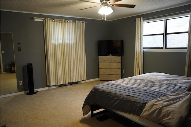 carpeted bedroom with ceiling fan, crown molding, and a textured ceiling