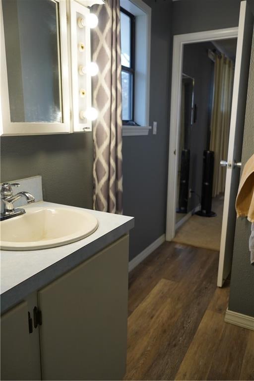 bathroom with hardwood / wood-style floors and vanity