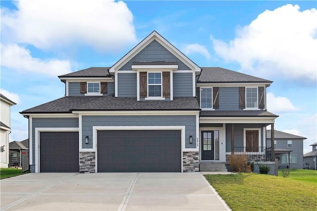 craftsman house with a porch, a garage, and a front yard