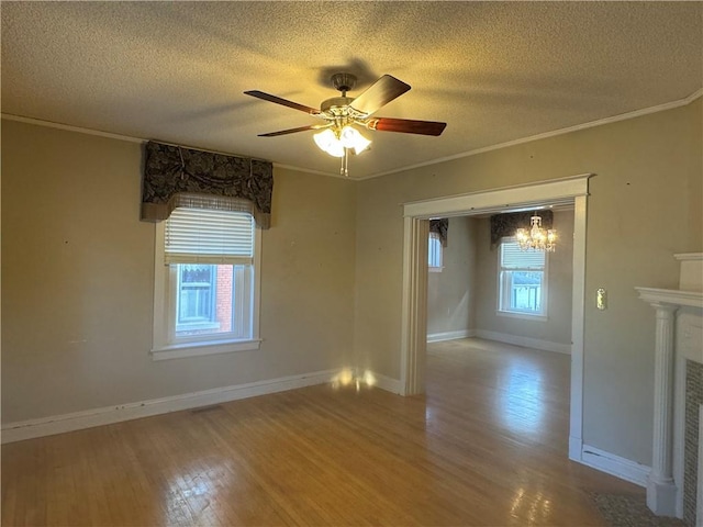 spare room with wood-type flooring, a textured ceiling, ceiling fan, and a healthy amount of sunlight