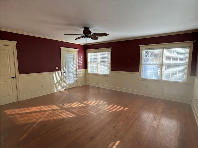 spare room with dark hardwood / wood-style floors, ceiling fan, and ornamental molding