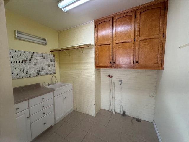 clothes washing area with sink and cabinets