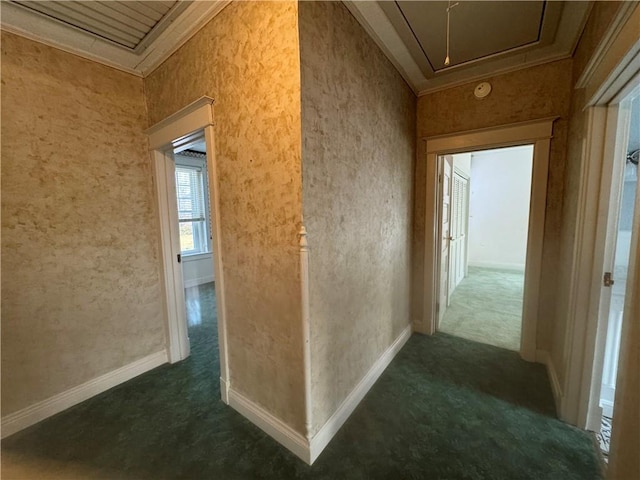 hallway featuring dark carpet and ornamental molding