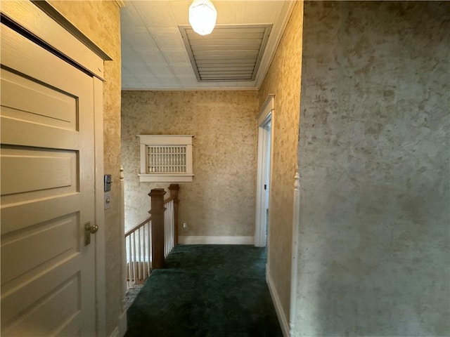 hallway featuring dark colored carpet and crown molding