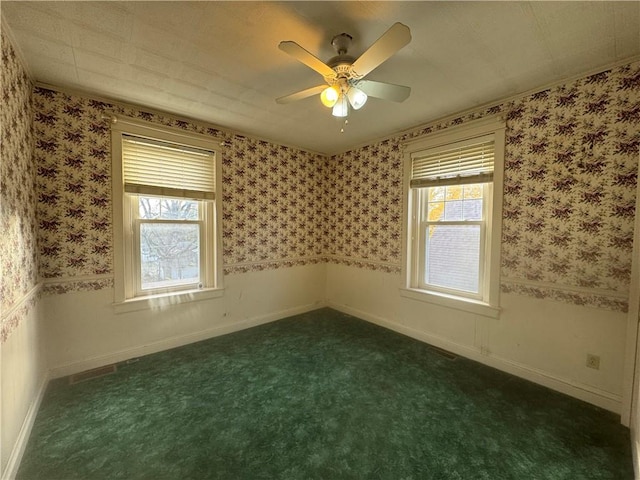 unfurnished room featuring dark carpet and ceiling fan