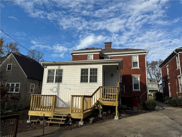 back of house with a deck