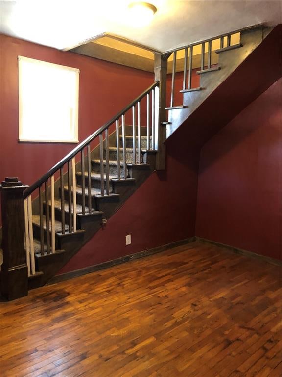 stairs featuring hardwood / wood-style flooring