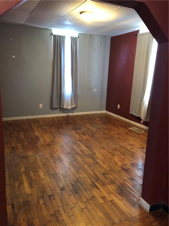 unfurnished room featuring dark wood-type flooring