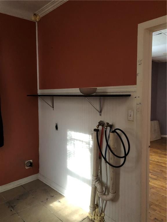 laundry room with hookup for an electric dryer, hookup for a washing machine, crown molding, and wood-type flooring