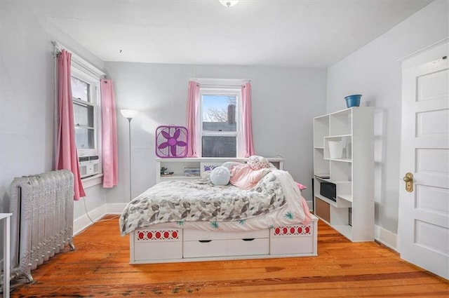 bedroom featuring light hardwood / wood-style flooring and cooling unit