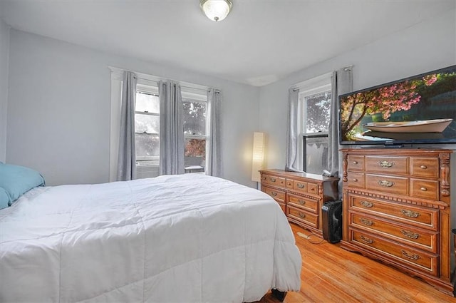 bedroom featuring light hardwood / wood-style flooring and multiple windows