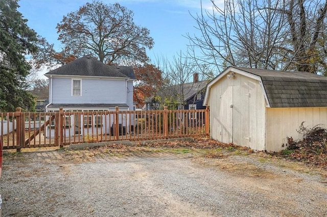 exterior space featuring a storage unit and a deck