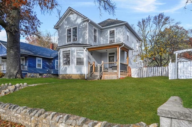 view of front of property featuring a porch, a front yard, and fence