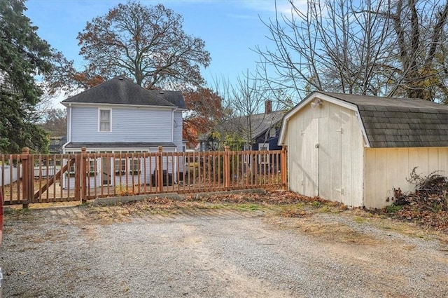 view of shed featuring fence