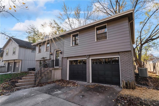 view of front of home featuring a garage and central AC unit