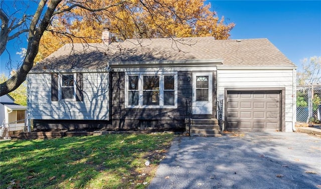 view of front facade featuring a garage and a front lawn