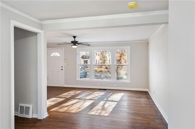 interior space featuring dark wood-type flooring, ornamental molding, and ceiling fan