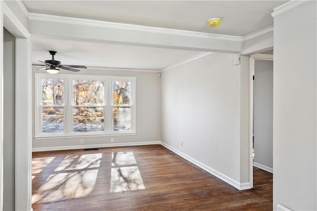 spare room featuring crown molding, dark wood-type flooring, and ceiling fan