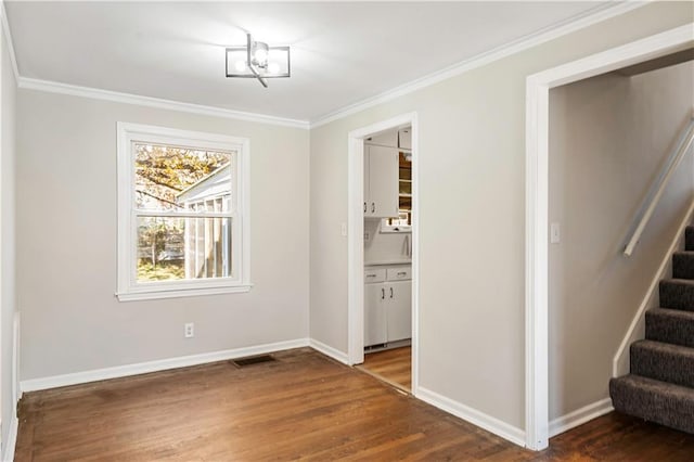 unfurnished dining area featuring ornamental molding and dark hardwood / wood-style floors