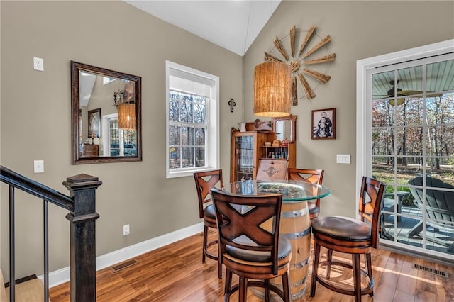 dining area with hardwood / wood-style floors and lofted ceiling