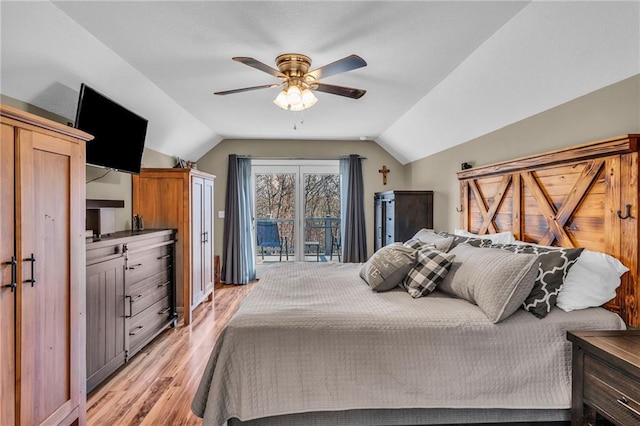 bedroom featuring ceiling fan, light hardwood / wood-style floors, access to exterior, and vaulted ceiling