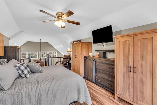 bedroom featuring ceiling fan, lofted ceiling, and light hardwood / wood-style flooring