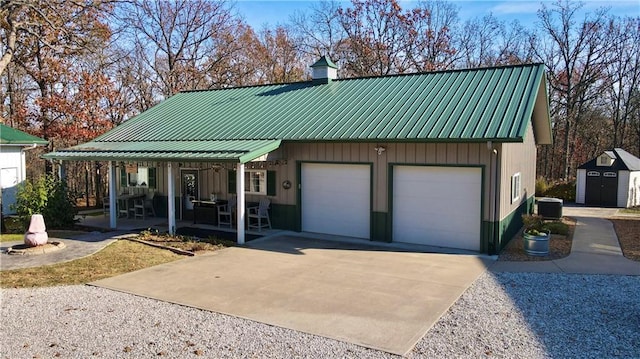 view of front of house with a shed, cooling unit, a porch, and a garage