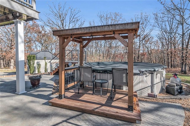 deck featuring a covered hot tub