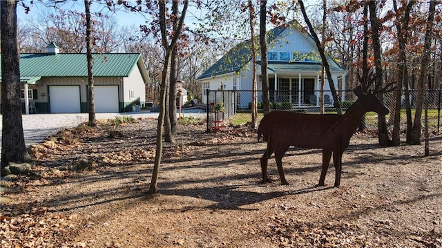 view of yard featuring a porch and a garage