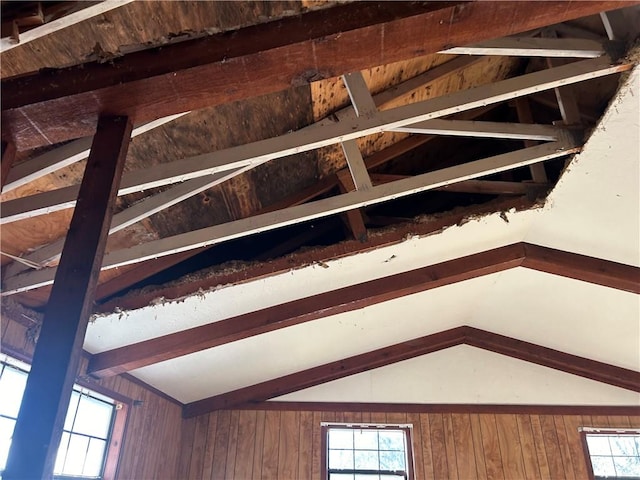 details featuring beamed ceiling and wood walls