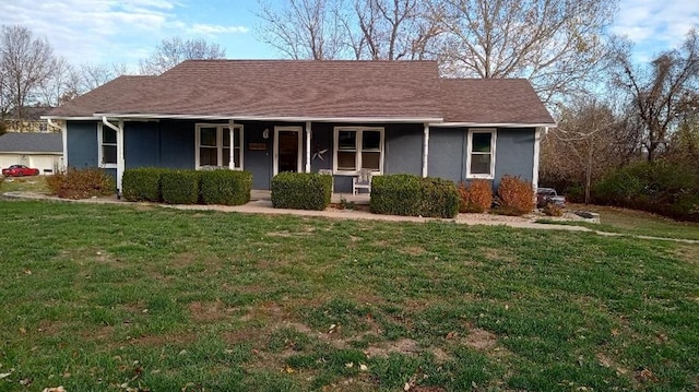 ranch-style home with covered porch, stucco siding, and a front yard