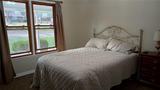 carpeted bedroom featuring multiple windows