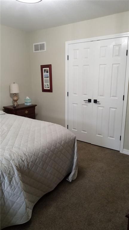 bedroom featuring a closet and dark carpet