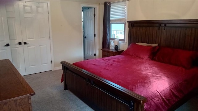 bedroom featuring light carpet and a closet