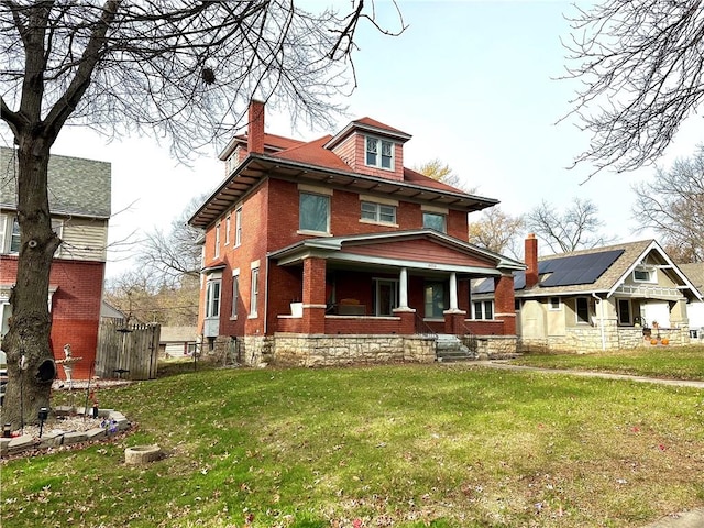 view of front of house with covered porch and a front yard