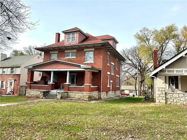 view of front of property with covered porch and a front yard