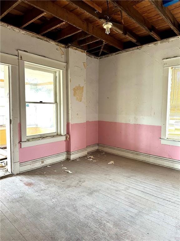 empty room featuring hardwood / wood-style flooring and wooden ceiling