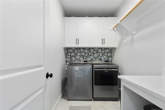 laundry area with cabinets and washer and clothes dryer