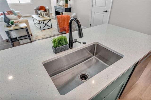 room details featuring sink and light stone countertops