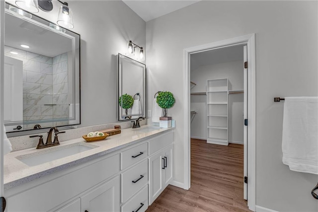 bathroom featuring wood-type flooring, vanity, and a shower