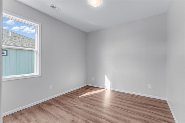 spare room with light hardwood / wood-style flooring