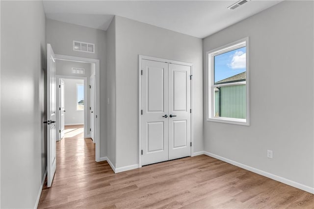 hall with light hardwood / wood-style flooring