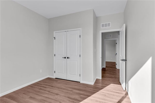 unfurnished bedroom featuring a closet and light hardwood / wood-style flooring